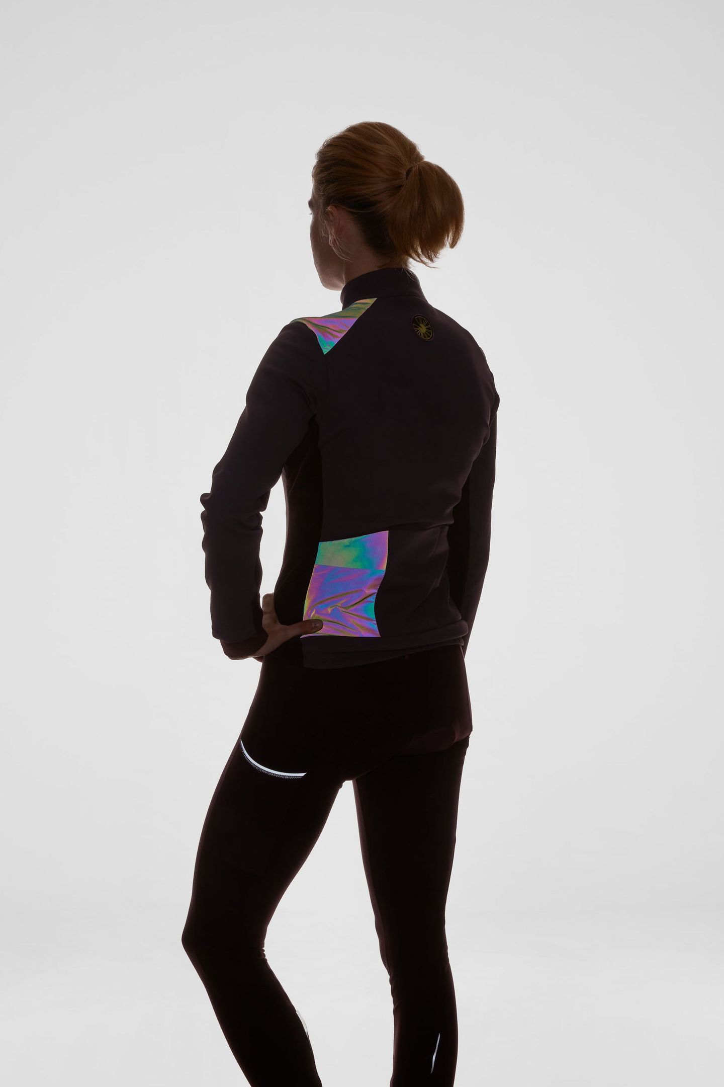 Integrated reflective, iridescent details for low light visibility